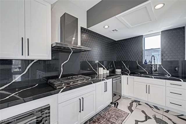 kitchen featuring light tile patterned floors, backsplash, and wall chimney exhaust hood