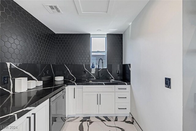 kitchen featuring sink, white cabinetry, and light tile patterned floors