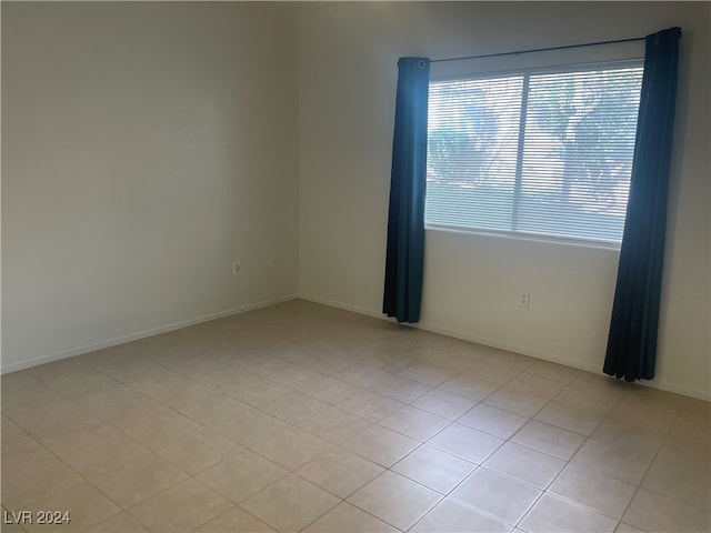 spare room featuring light tile patterned floors