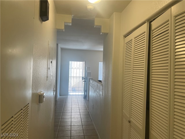 hallway with tile patterned floors