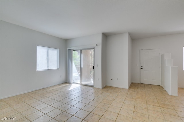 unfurnished room featuring light tile patterned floors