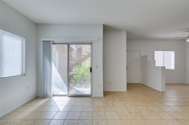 entryway with light tile patterned floors and ceiling fan