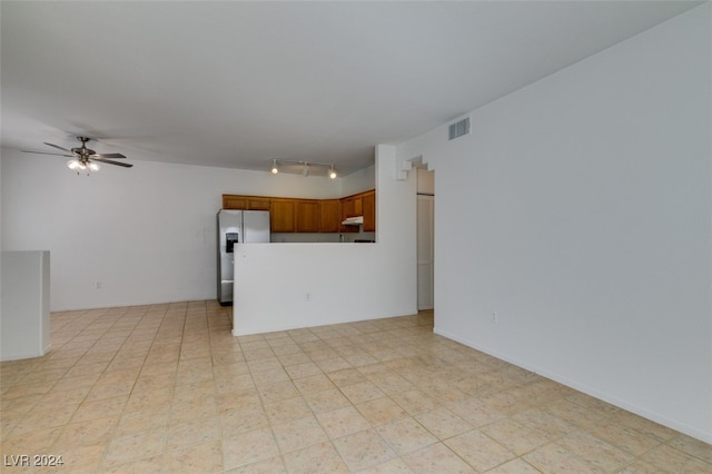 interior space featuring ceiling fan and rail lighting