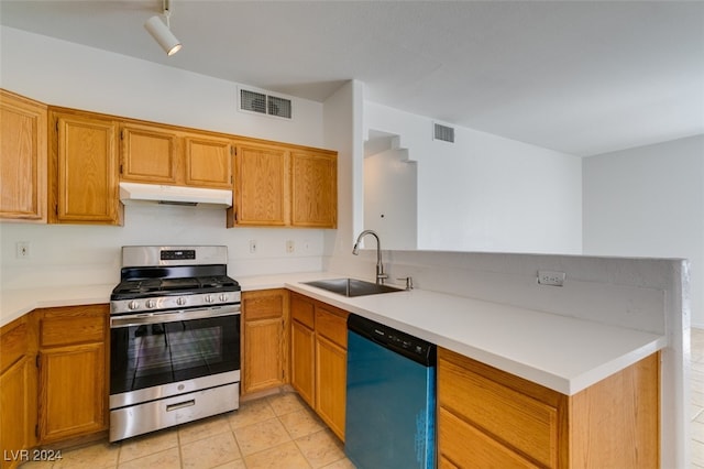 kitchen with appliances with stainless steel finishes, light tile patterned flooring, and sink