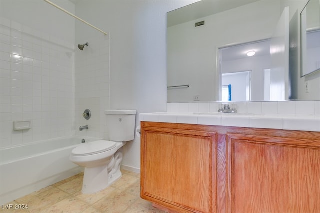 full bathroom featuring tile patterned floors, tiled shower / bath combo, vanity, and toilet