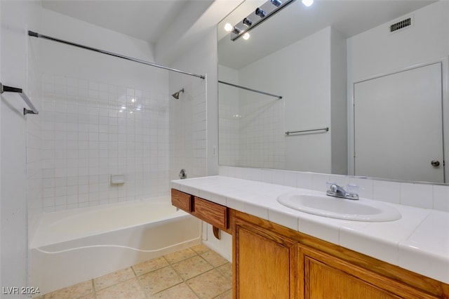 bathroom with vanity, tile patterned floors, and tiled shower / bath