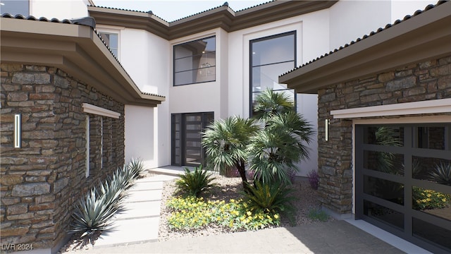 doorway to property with stone siding, a tiled roof, and stucco siding