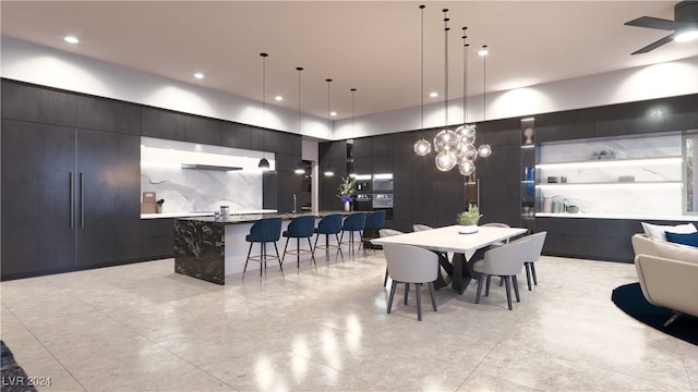 tiled dining area featuring ceiling fan with notable chandelier