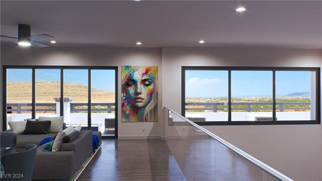 interior space featuring ceiling fan, a mountain view, and dark wood-type flooring