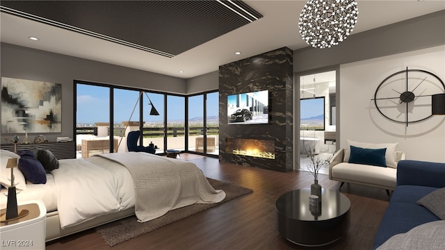 bedroom with a chandelier, recessed lighting, a large fireplace, and wood finished floors