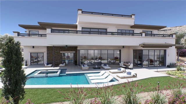 back of property with a patio, a ceiling fan, a balcony, and stucco siding