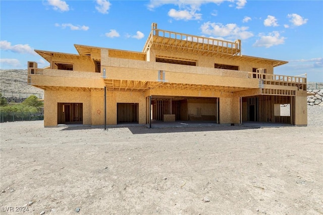 rear view of house with stucco siding