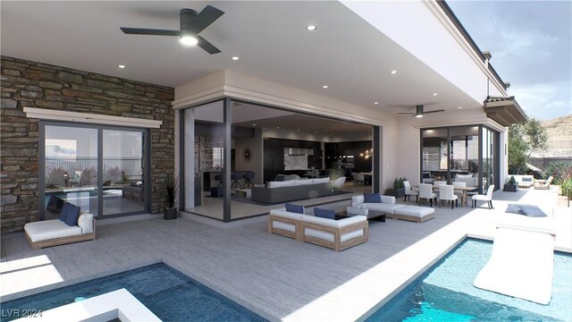 view of pool with ceiling fan, an outdoor living space, and a patio