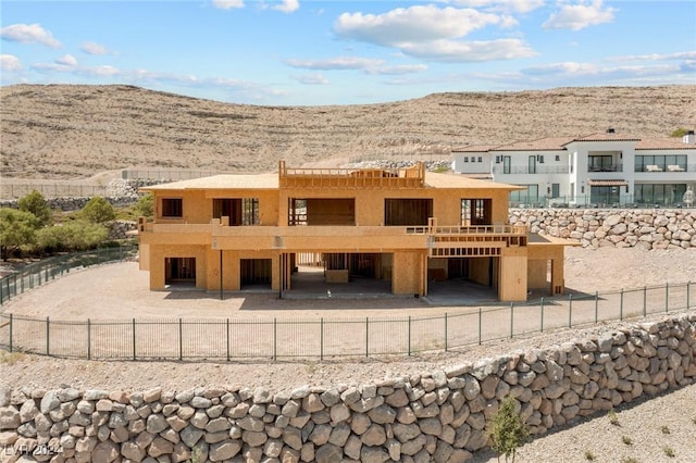 rear view of property featuring a mountain view and stucco siding