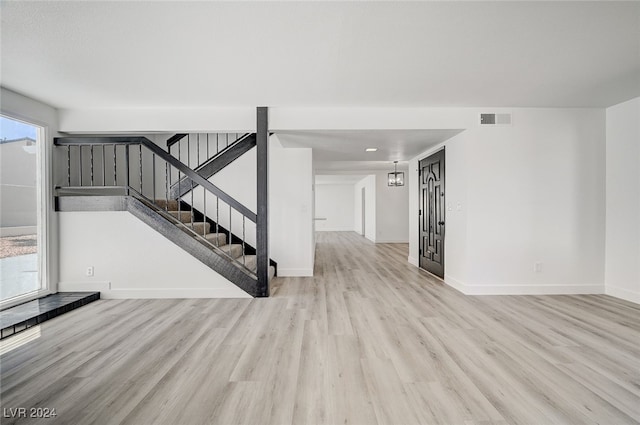 unfurnished living room with light wood-type flooring