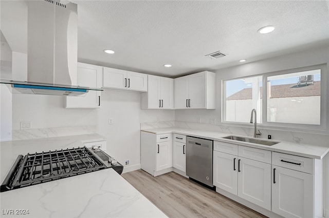 kitchen with light hardwood / wood-style floors, island range hood, stainless steel dishwasher, white cabinetry, and sink