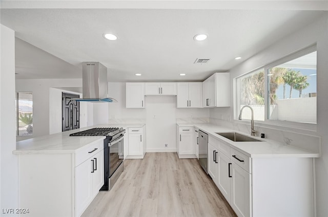 kitchen featuring appliances with stainless steel finishes, light hardwood / wood-style flooring, island range hood, sink, and light stone countertops