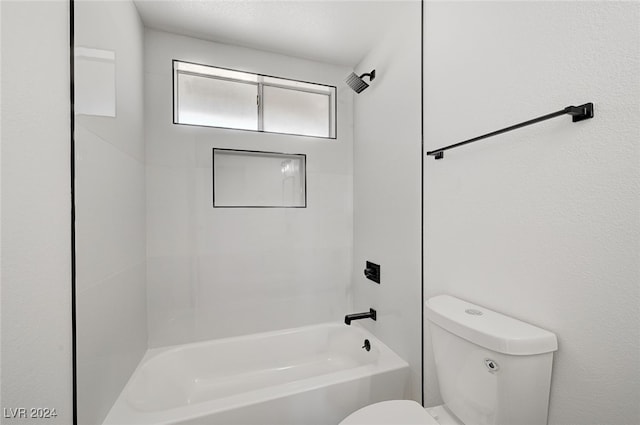 bathroom featuring shower / bathing tub combination and toilet