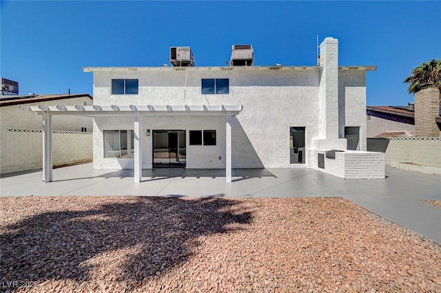 rear view of house featuring a patio and a pergola