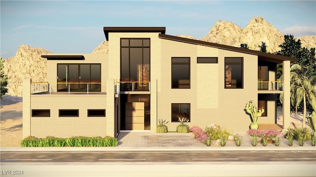 contemporary house featuring a garage, a balcony, and a mountain view