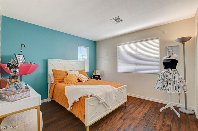 bedroom with dark hardwood / wood-style floors