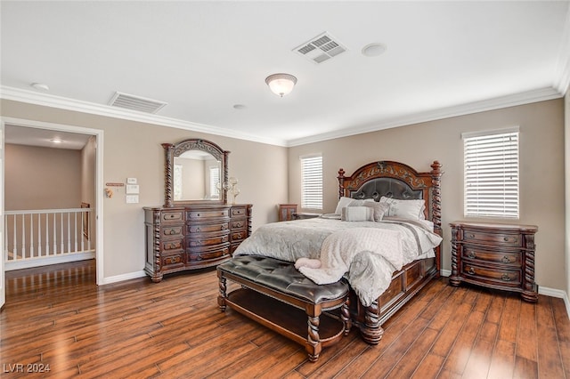 bedroom featuring multiple windows, hardwood / wood-style floors, and ornamental molding