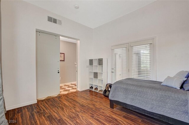 bedroom with hardwood / wood-style flooring