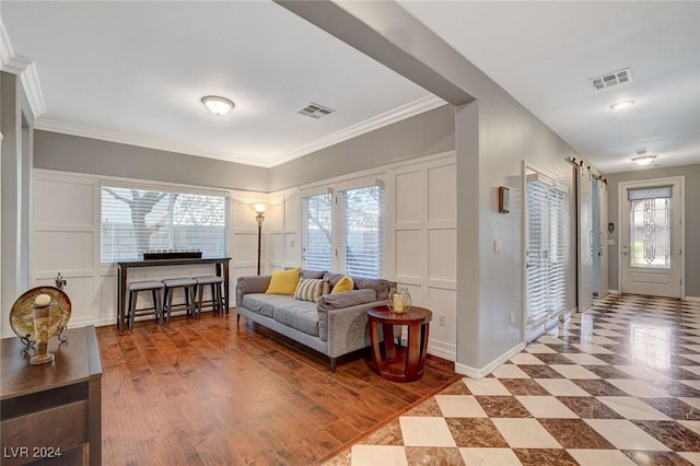 living room featuring ornamental molding and hardwood / wood-style flooring