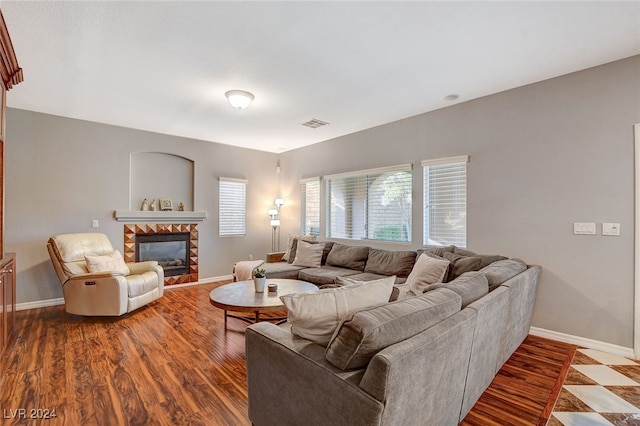 living room with hardwood / wood-style flooring and a fireplace