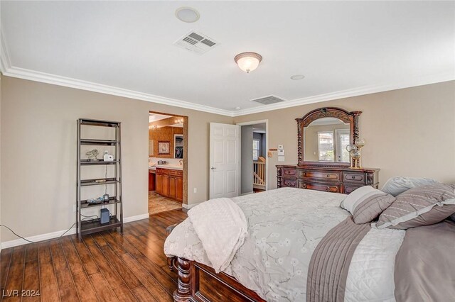 bedroom with ornamental molding, hardwood / wood-style flooring, and ensuite bathroom