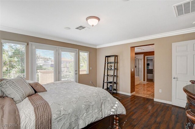 bedroom featuring dark hardwood / wood-style flooring, access to exterior, multiple windows, and ornamental molding