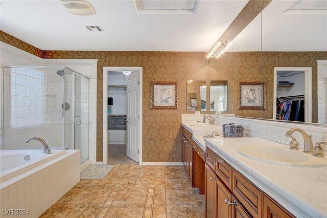 bathroom with shower with separate bathtub, double vanity, and tile patterned floors