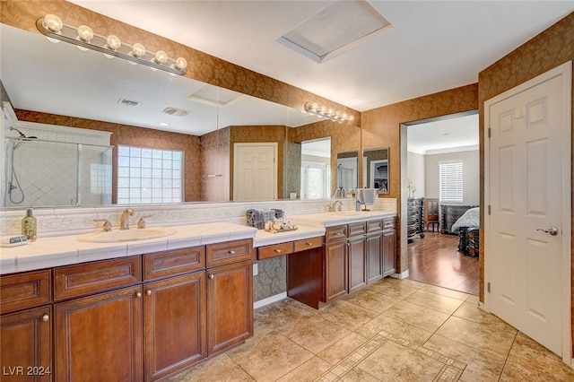 bathroom featuring hardwood / wood-style floors, double sink vanity, and ornamental molding