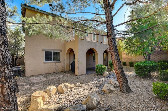 mediterranean / spanish house with a patio and central AC