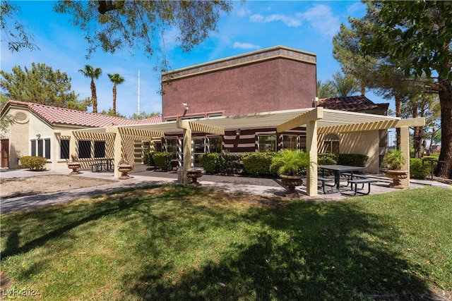 rear view of house featuring a lawn, a pergola, and a patio area