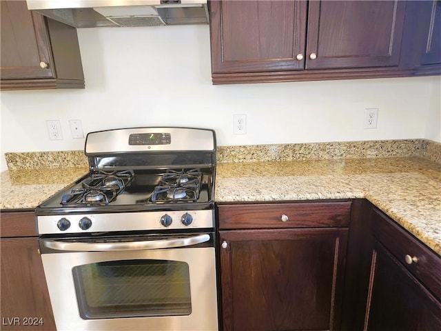 kitchen with wall chimney range hood and stainless steel range with gas stovetop