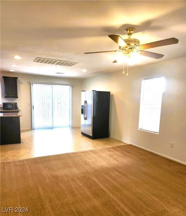 unfurnished living room with light carpet, recessed lighting, visible vents, and a ceiling fan