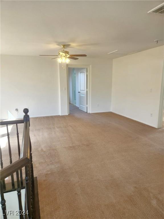 empty room with carpet and ceiling fan