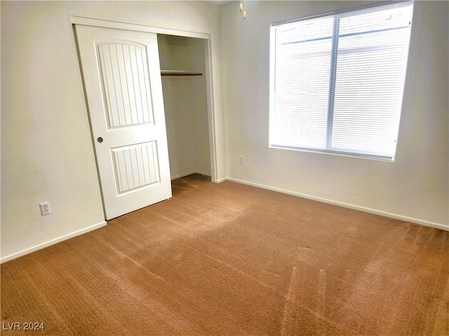 unfurnished bedroom featuring a closet, carpet flooring, and baseboards