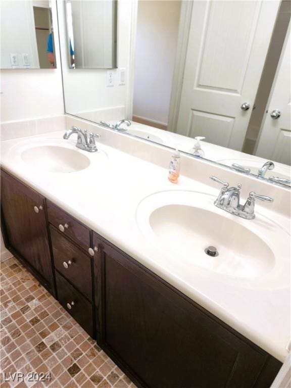 full bath featuring a sink and double vanity