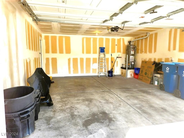 garage with water heater and a garage door opener