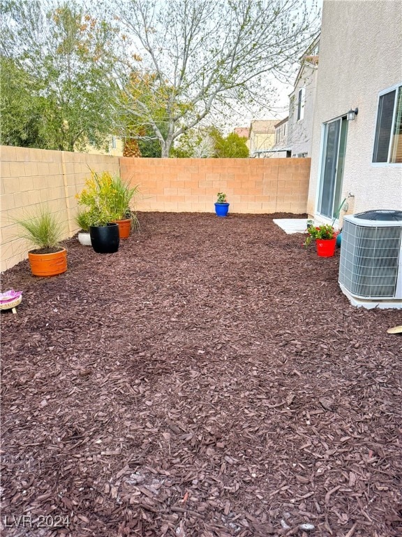 view of yard featuring a fenced backyard and central AC unit