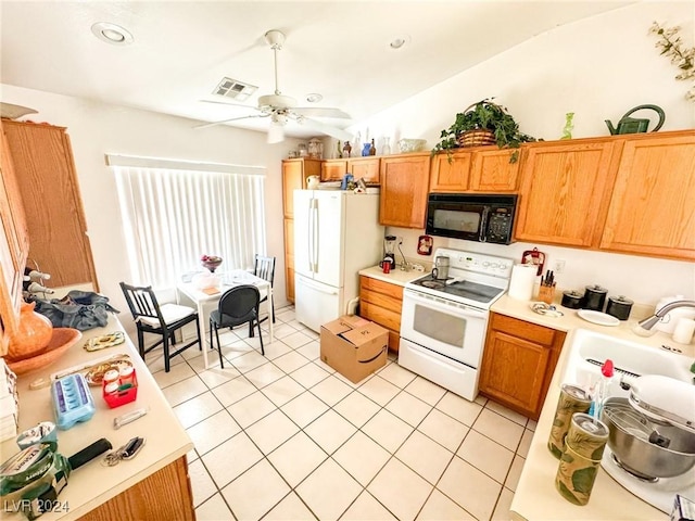 kitchen with sink, vaulted ceiling, light tile patterned floors, ceiling fan, and white appliances