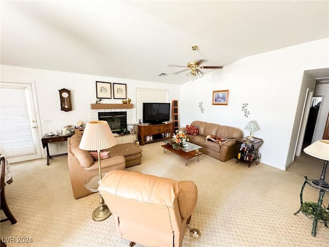 carpeted living room featuring ceiling fan, lofted ceiling, and a fireplace