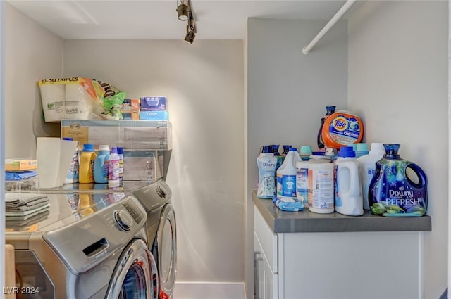 laundry room with track lighting and washing machine and dryer