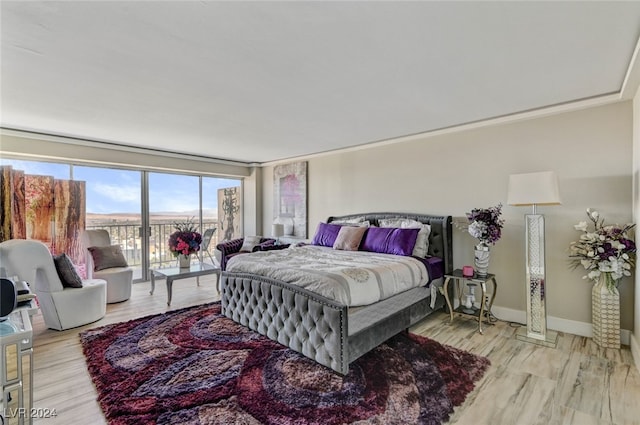 bedroom featuring light hardwood / wood-style floors and ornamental molding