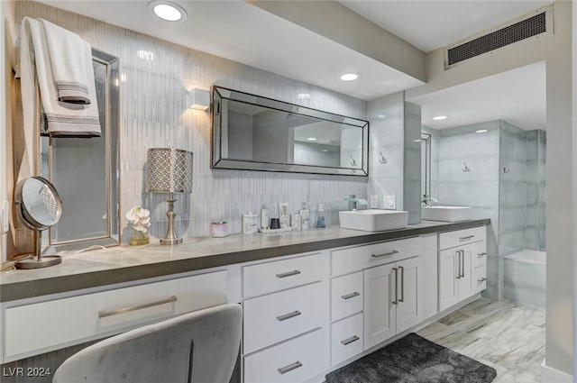 bathroom featuring vanity and independent shower and bath