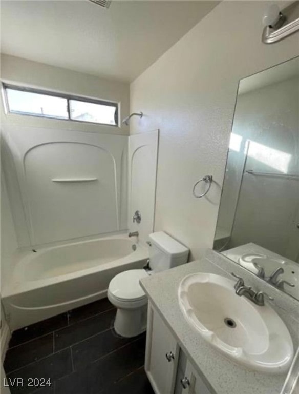 full bathroom featuring toilet, washtub / shower combination, vanity, and tile patterned floors