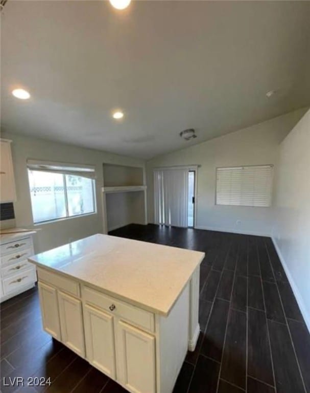 kitchen featuring a kitchen island, white cabinets, and dark hardwood / wood-style flooring