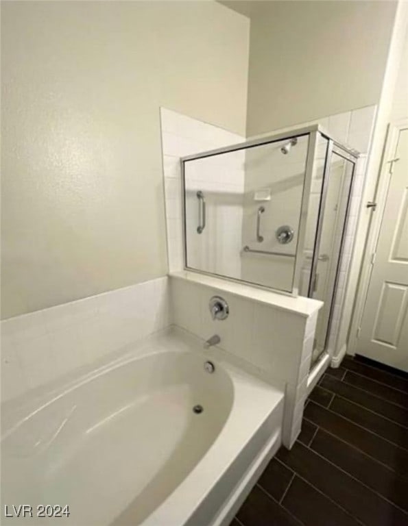 bathroom featuring tile patterned flooring and independent shower and bath